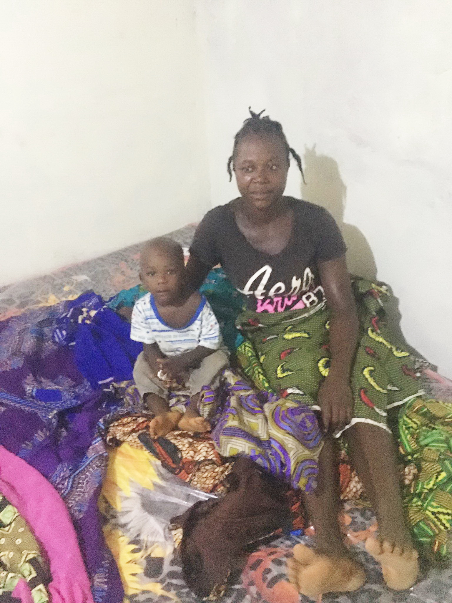 Hannah is sitting on her new King size mattress amid all the new dresses Daniel Keamue bought for her.  We also paid for a year of rent. Next we will empower her with a small business so that she can provide for her children.