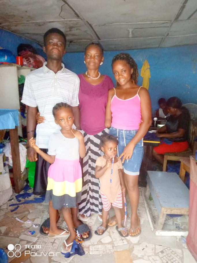 Fatu and her children at the place she sews.