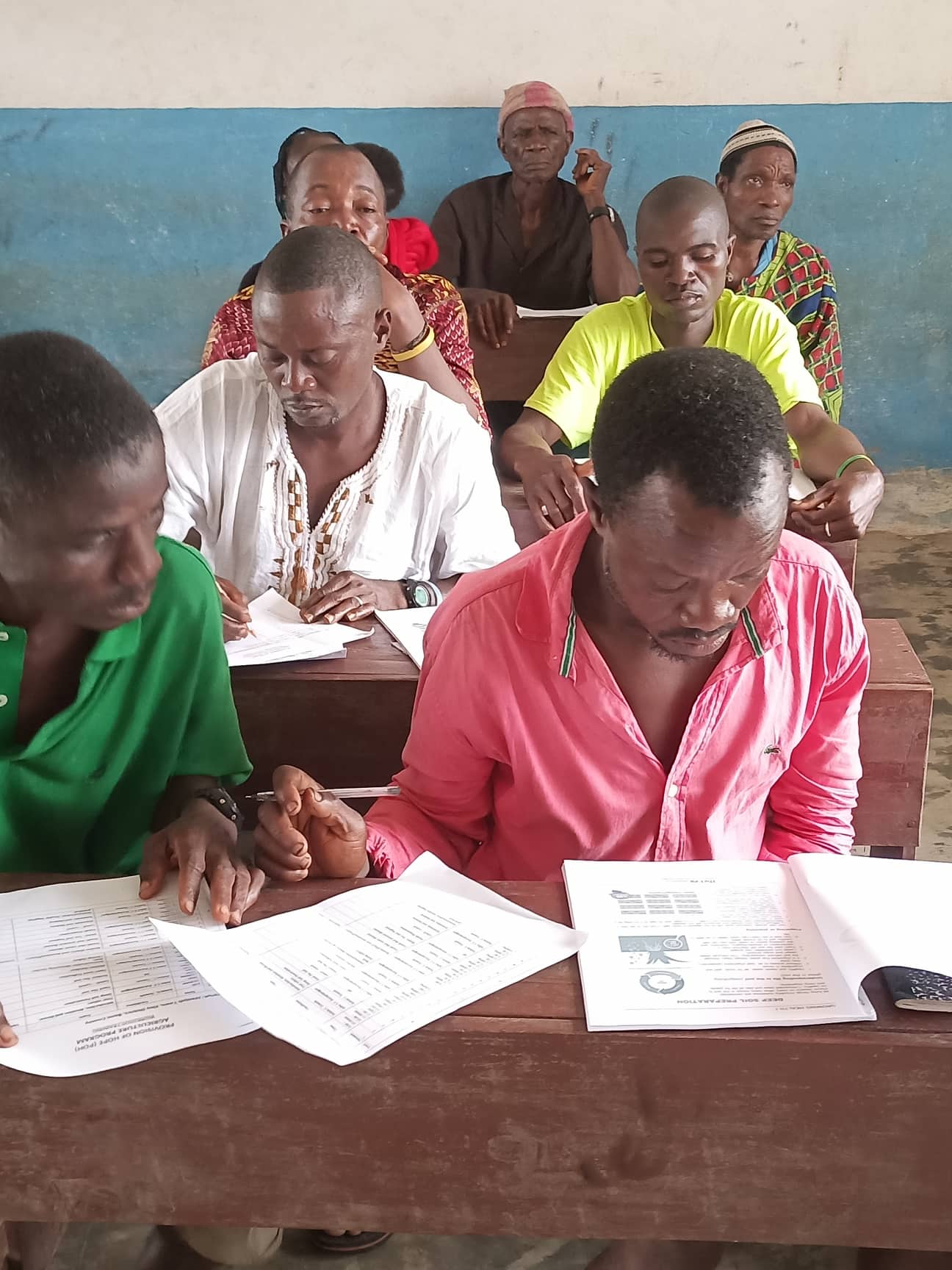 Farmers are studying the Grow Health lessons in one of the workshops in Dodee Village.