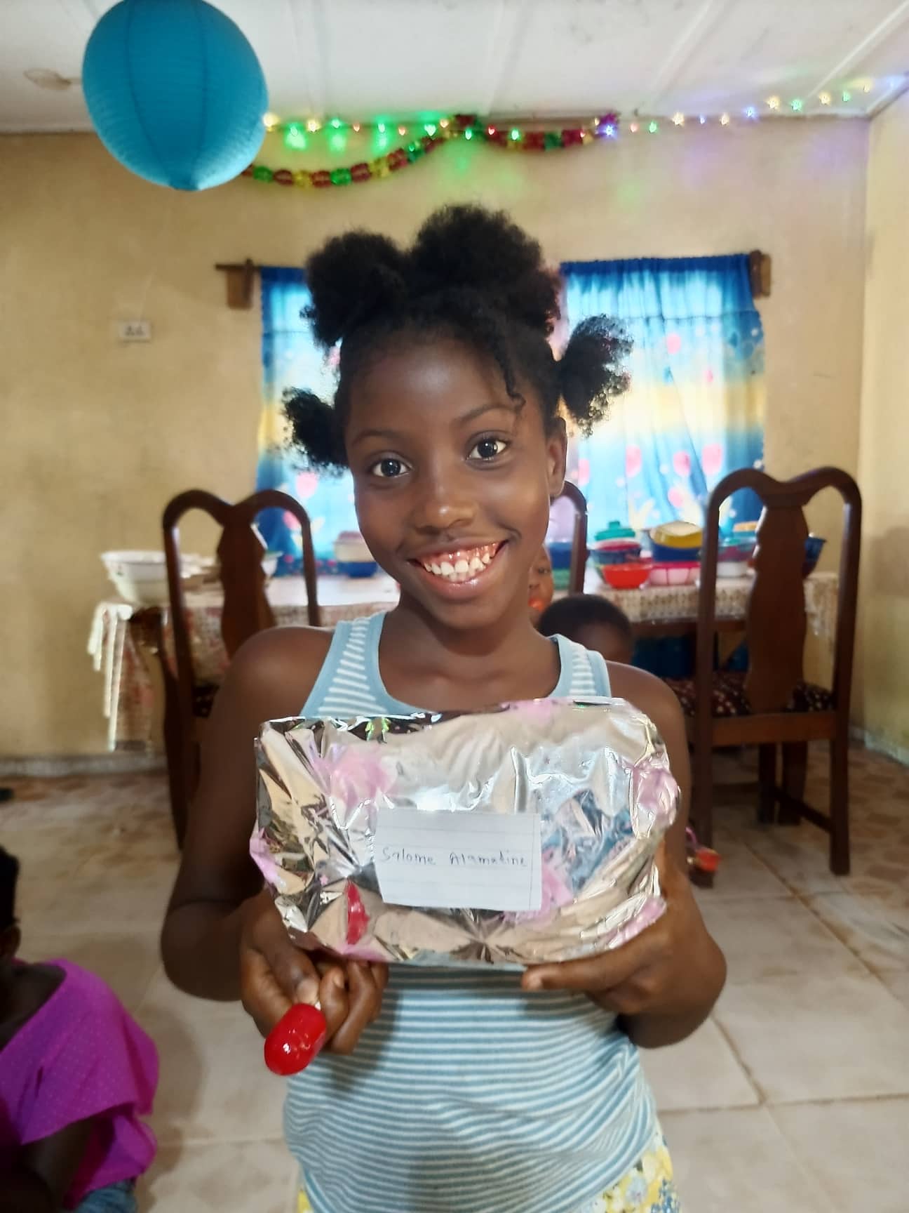 Each Child Gets a Wraped Gift!! Salome holds hers!