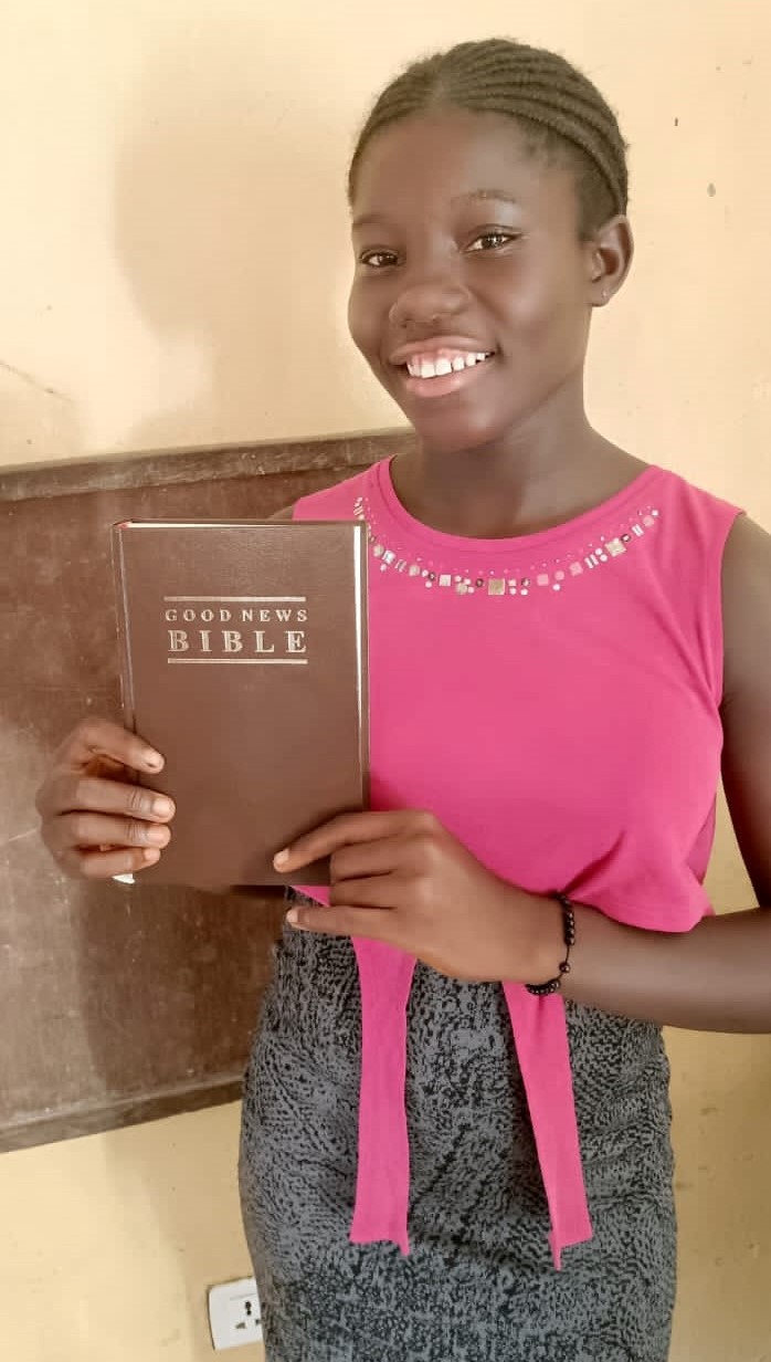 Favor can't wait to read her new Bible.  She lives with Eric and Kamah.