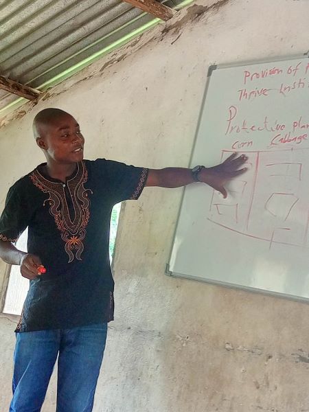Preston is instructing in his first workshop in Tudin Town. He is the Agriculture Teacher at Hope Academy in Ganta.