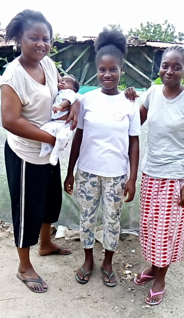 This is a photo taken in April 2022 at the Buduburam Refugee Camp. Ruth is holding her little neice. Gifty is in the middle.
