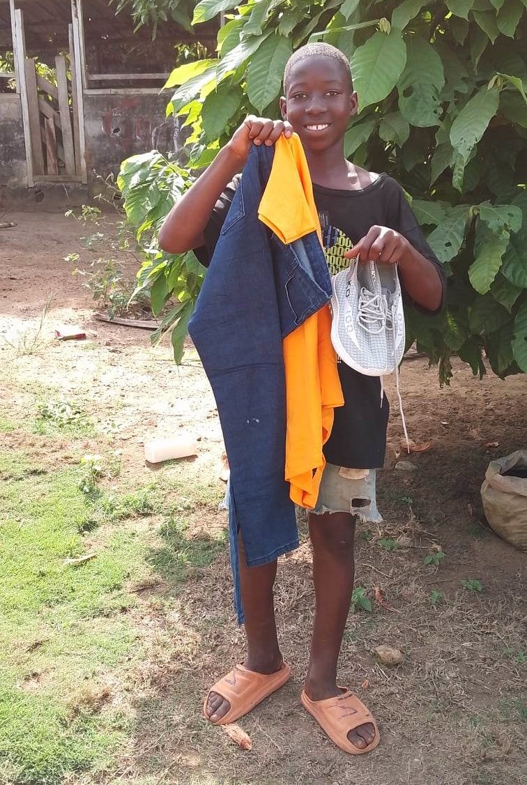 James holds up his new clothes. Beautiful!  They are so very grateful!