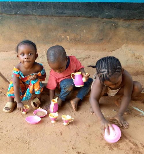 Little Rita just came last week. She is the one on the left. They are cooking up jollof rice for Papa Dapae.