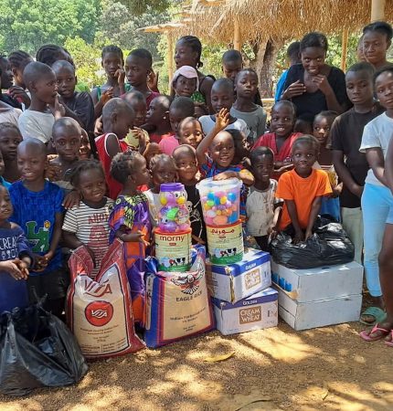 Children gathering around the supplies