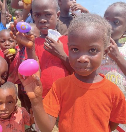 Children proudly show their eggs with candies inside