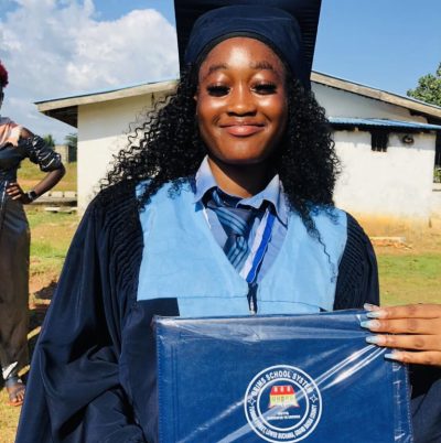 Hawa holds her diploma