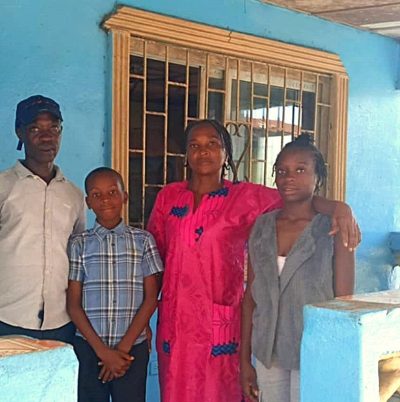 Kollie Family in front of their new place