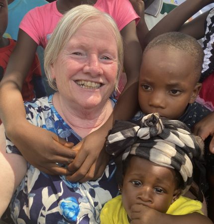 Mae Clowe surrounded by the children