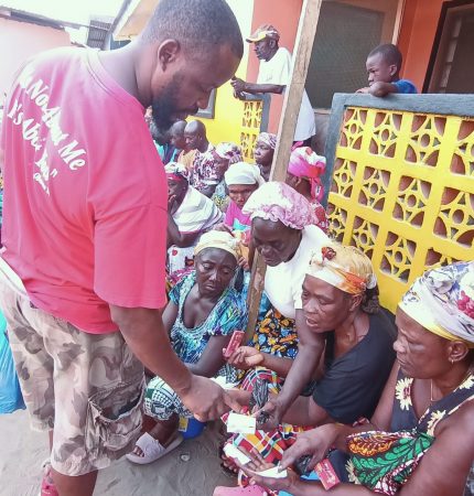 Pharmacy Assistant Joseph Sackie helps with medications for our widows